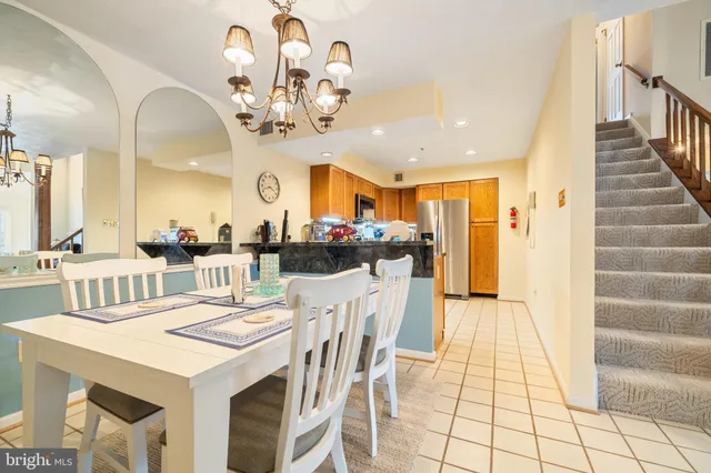 a view of a dining room with furniture and a chandelier