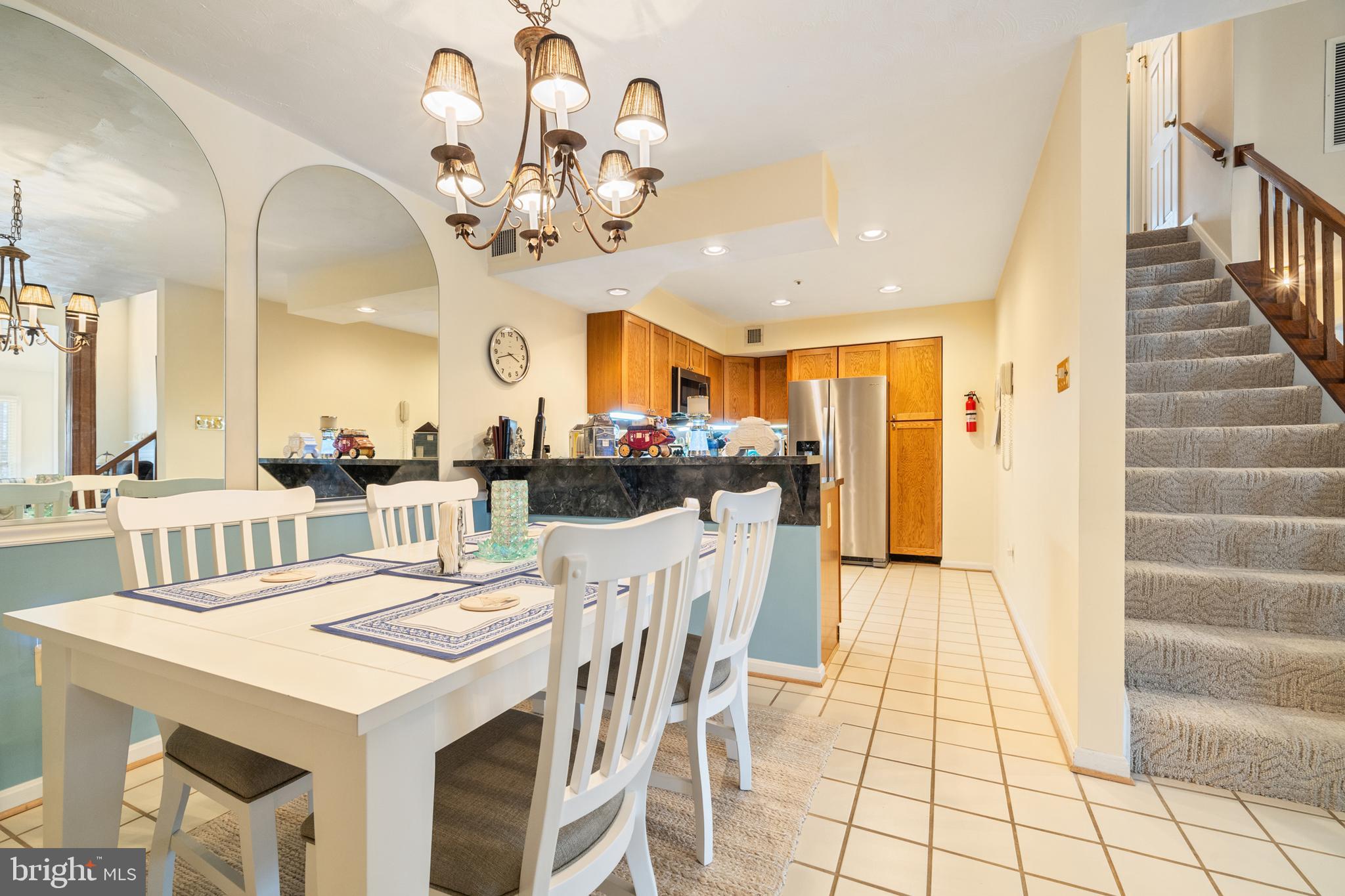 2702 Summerview Way, Unit 303 Annapolis, MD 21401 - Photo 6 of 35 a view of a dining room with furniture and a chandelier
