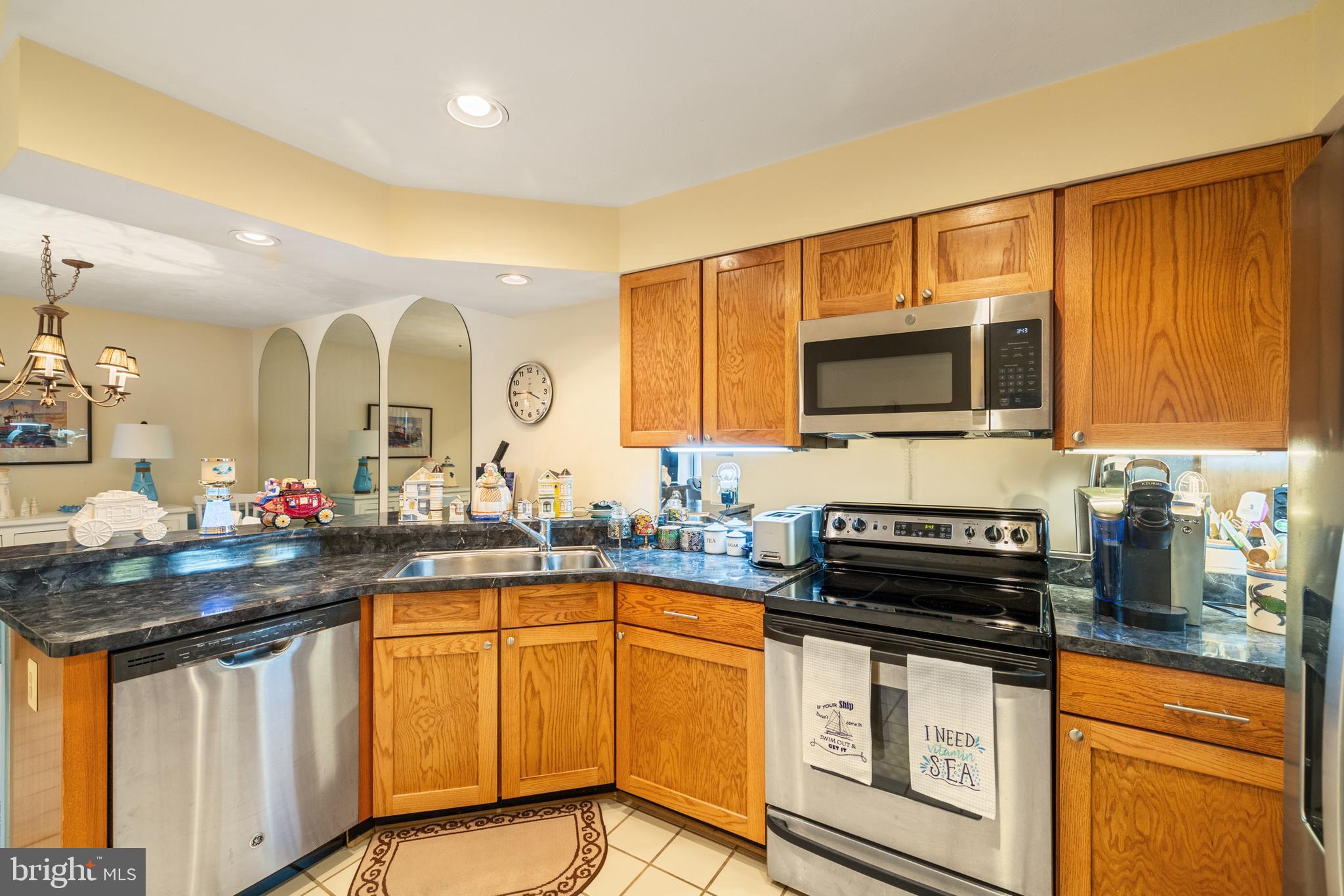 2702 Summerview Way, Unit 303 Annapolis, MD 21401 - Photo 7 of 35 a kitchen with stainless steel appliances granite countertop a stove a sink and a microwave
