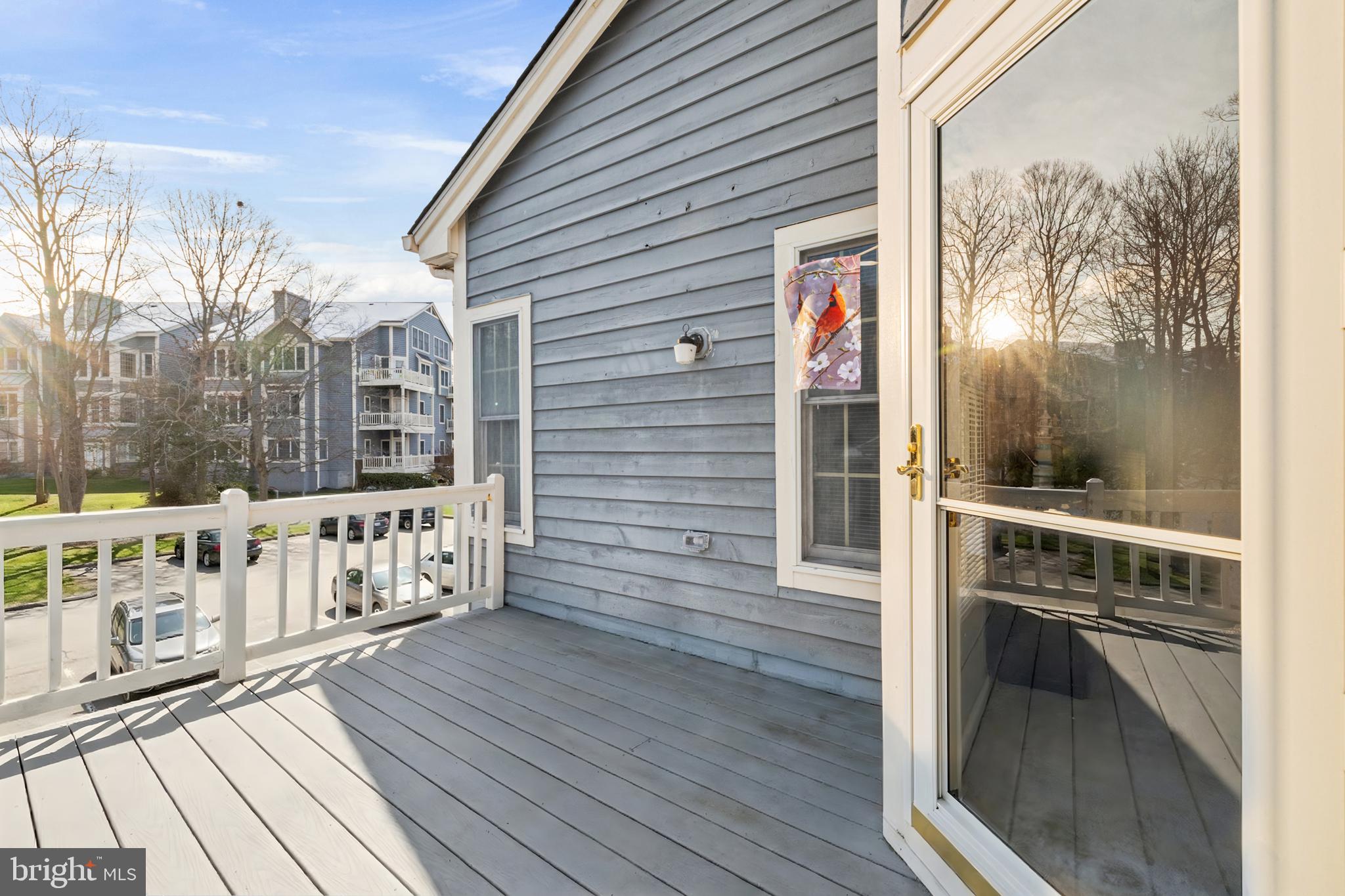 2702 Summerview Way, Unit 303 Annapolis, MD 21401 - Photo 9 of 35 a view of a balcony with wooden floor and iron stairs