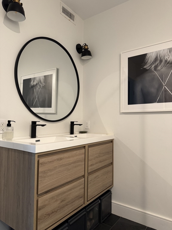 347 Maverick Street, Unit 5 Boston, MA 02128 - Photo 12 of 15 a bathroom with a sink and a mirror