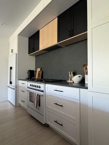 a view of kitchen with stainless steel appliances kitchen island dining table and chairs