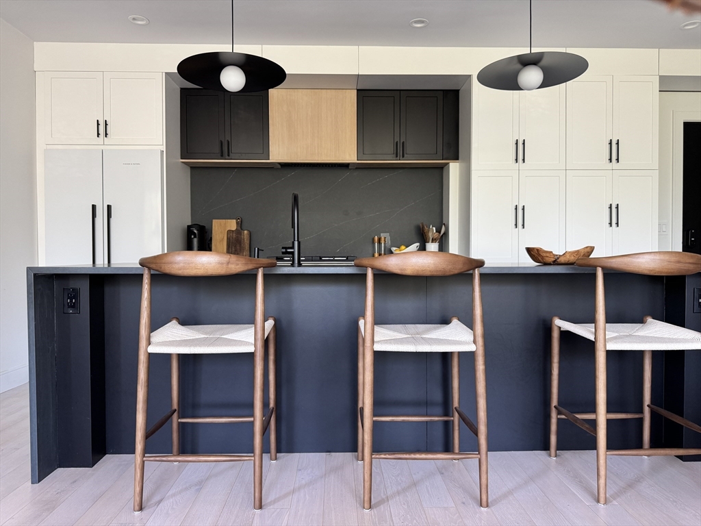 347 Maverick Street, Unit 5 Boston, MA 02128 - Photo 10 of 15 a view of kitchen with stainless steel appliances kitchen island dining table and chairs