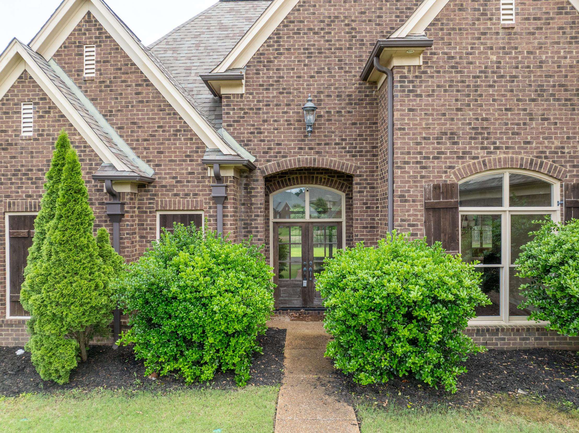 5380 Scarlet Ridge Drive Arlington, TN 38002 - Photo 25 of 35 Brick exterior featuring multiple gables, arched entry, double front doors, arched windows, and decorative shutters