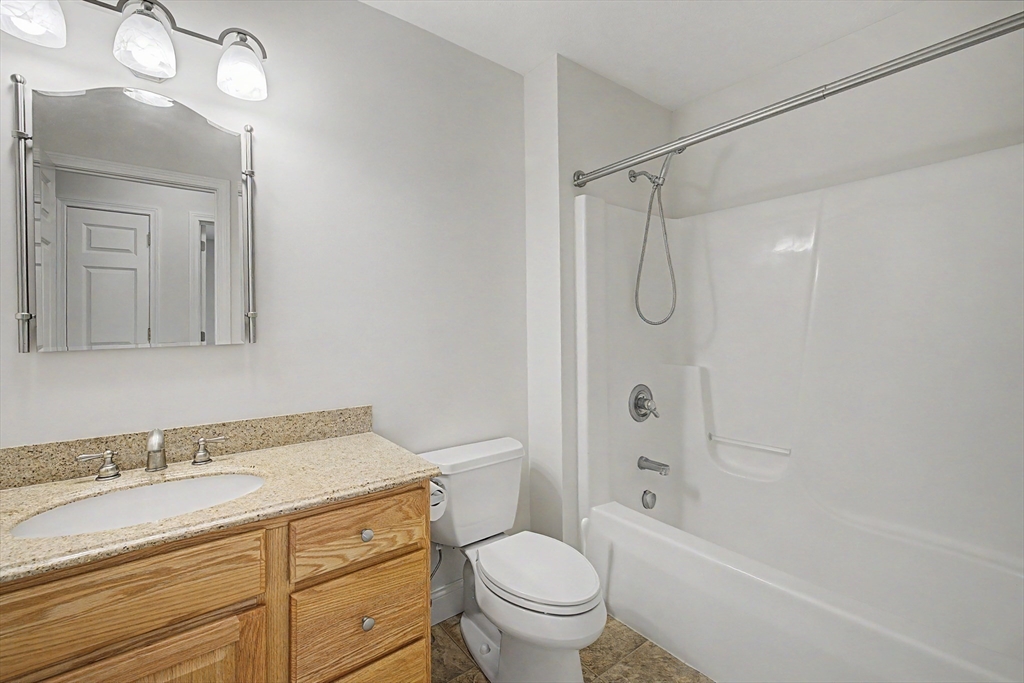 792 Ryan Road Northampton, MA 01062 - Photo 18 of 29 a bathroom with a granite countertop sink a toilet and shower