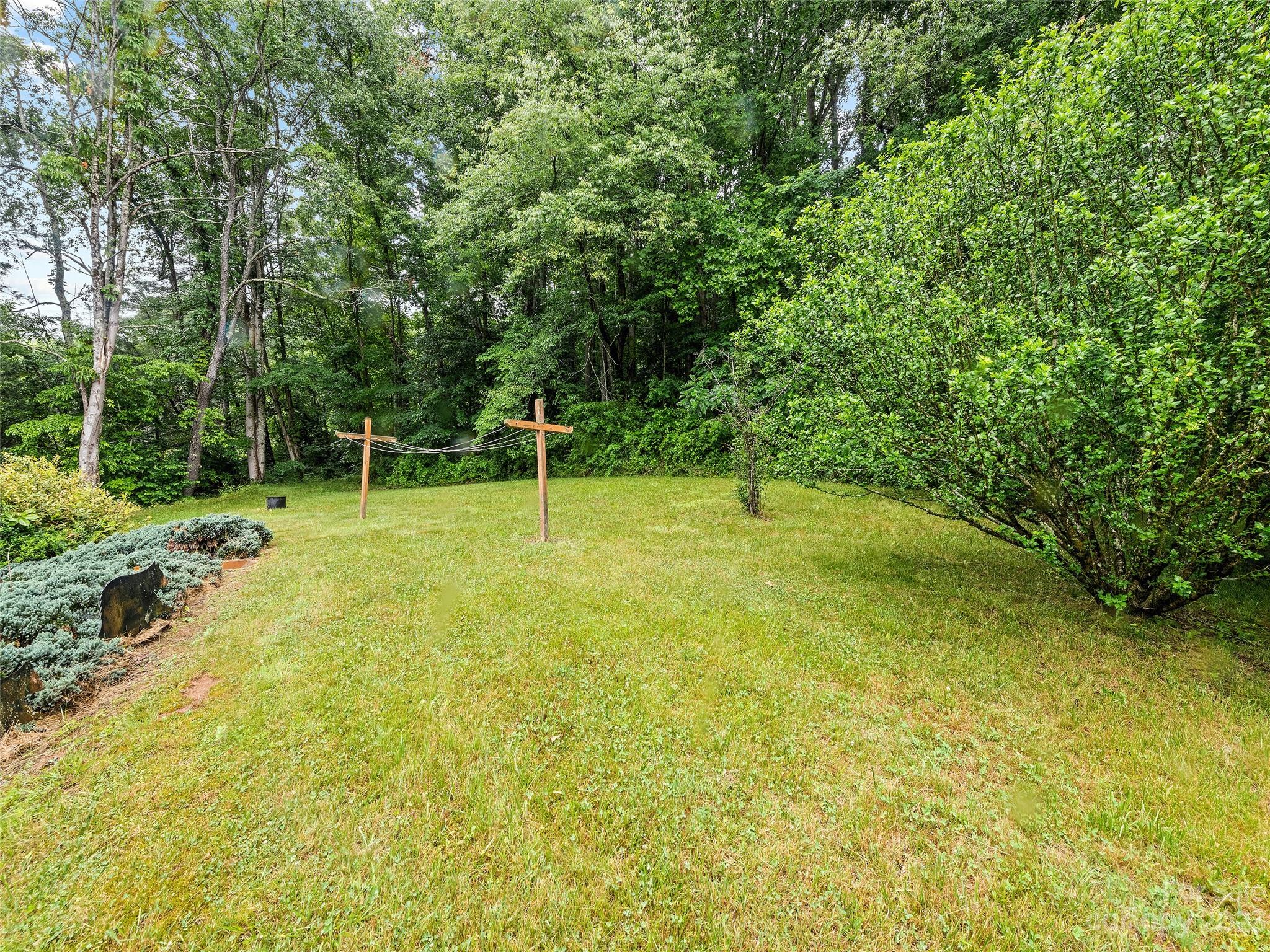 205 Columbus Cove Road Waynesville, NC 28785 - Photo 15 of 33 a backyard of a house with swimming pool and green space