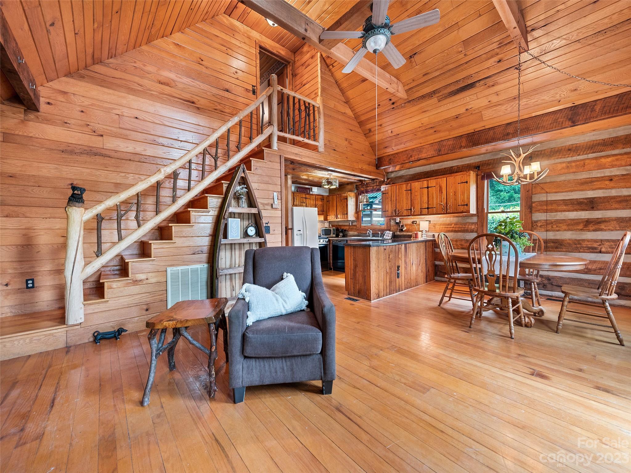 205 Columbus Cove Road Waynesville, NC 28785 - Photo 20 of 33 a dining room with furniture entryway and wooden floor