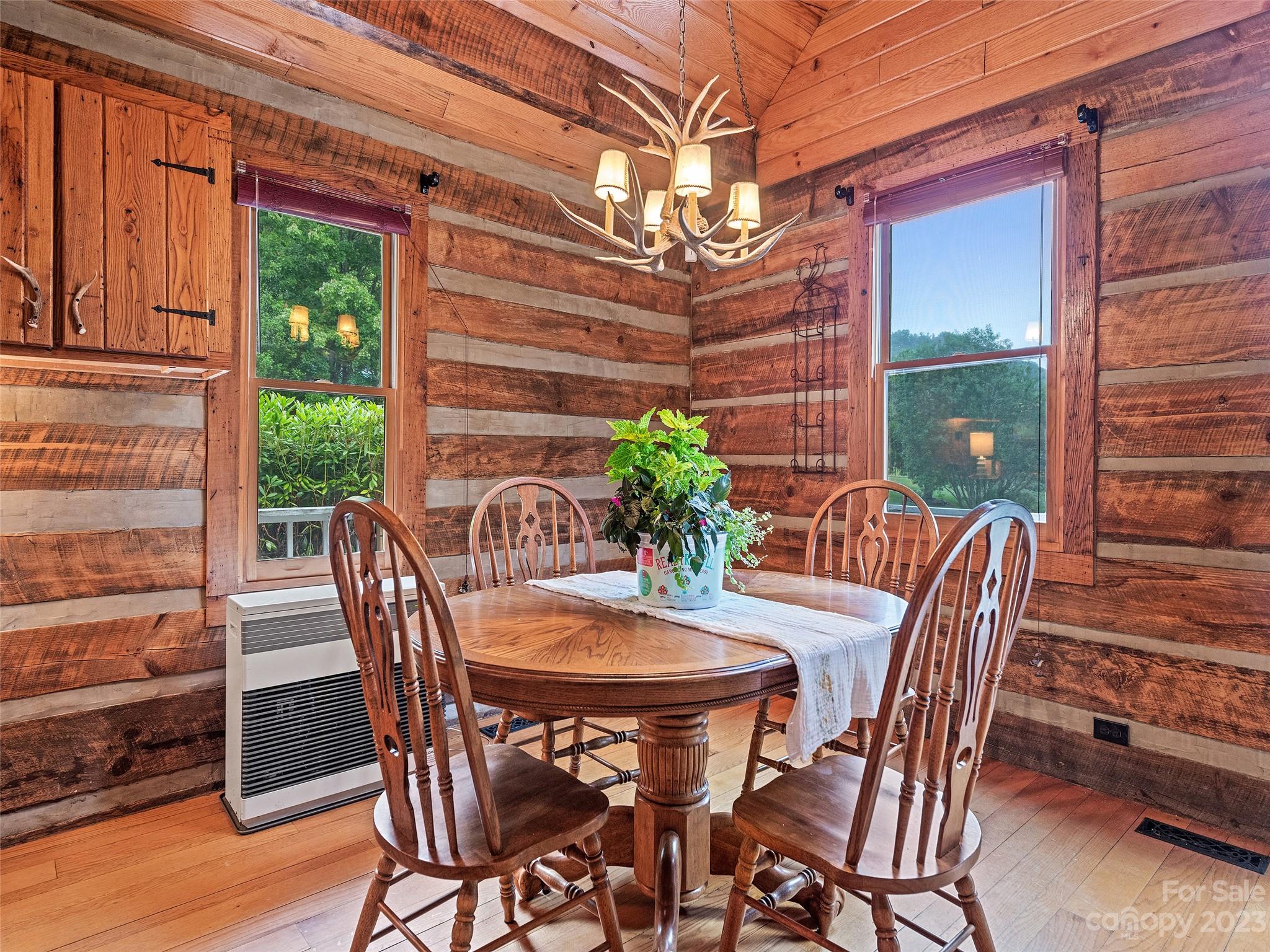 205 Columbus Cove Road Waynesville, NC 28785 - Photo 23 of 33 a view of a dining table and chairs in the patio