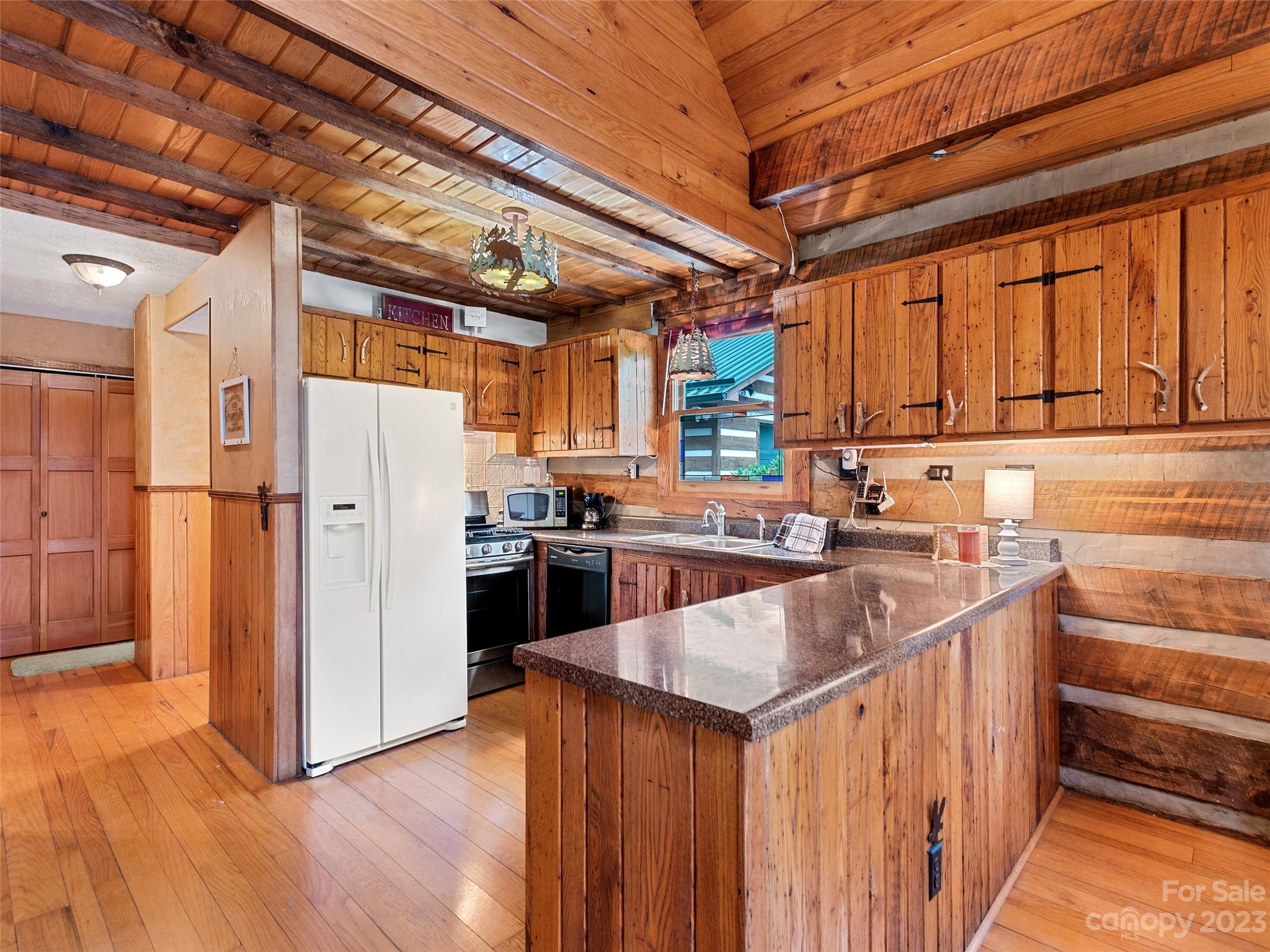205 Columbus Cove Road Waynesville, NC 28785 - Photo 25 of 33 a kitchen with refrigerator and cabinets