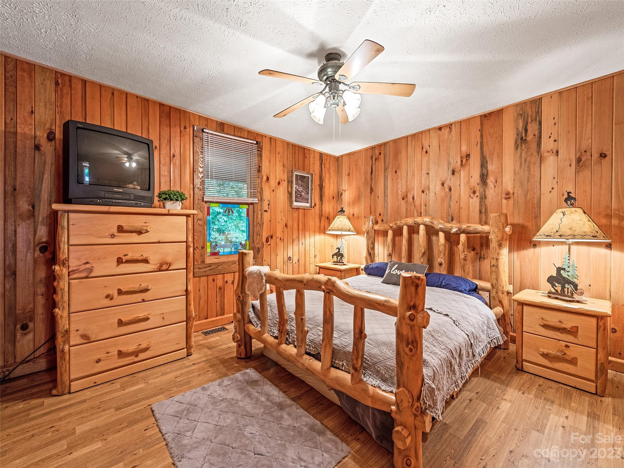 205 Columbus Cove Road Waynesville, NC 28785 - Photo 29 of 33 a bedroom with furniture and a flat screen tv