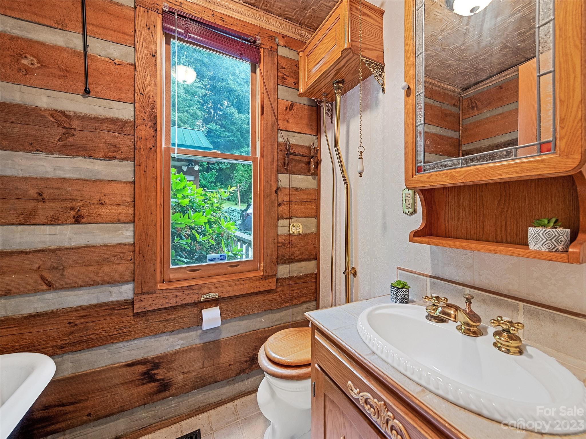 205 Columbus Cove Road Waynesville, NC 28785 - Photo 30 of 33 a bathroom with a sink a toilet and tub