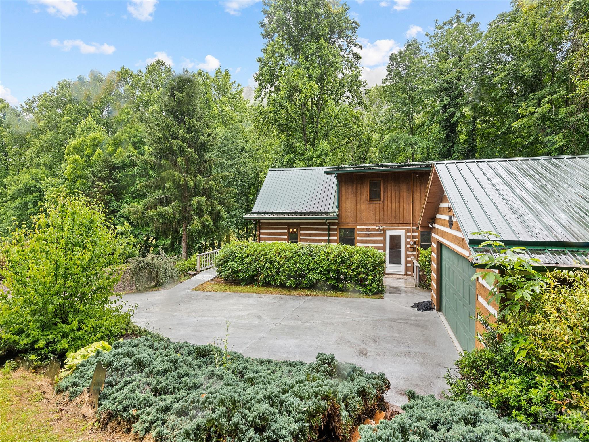 205 Columbus Cove Road Waynesville, NC 28785 - Photo 6 of 33 a view of a backyard with potted plants