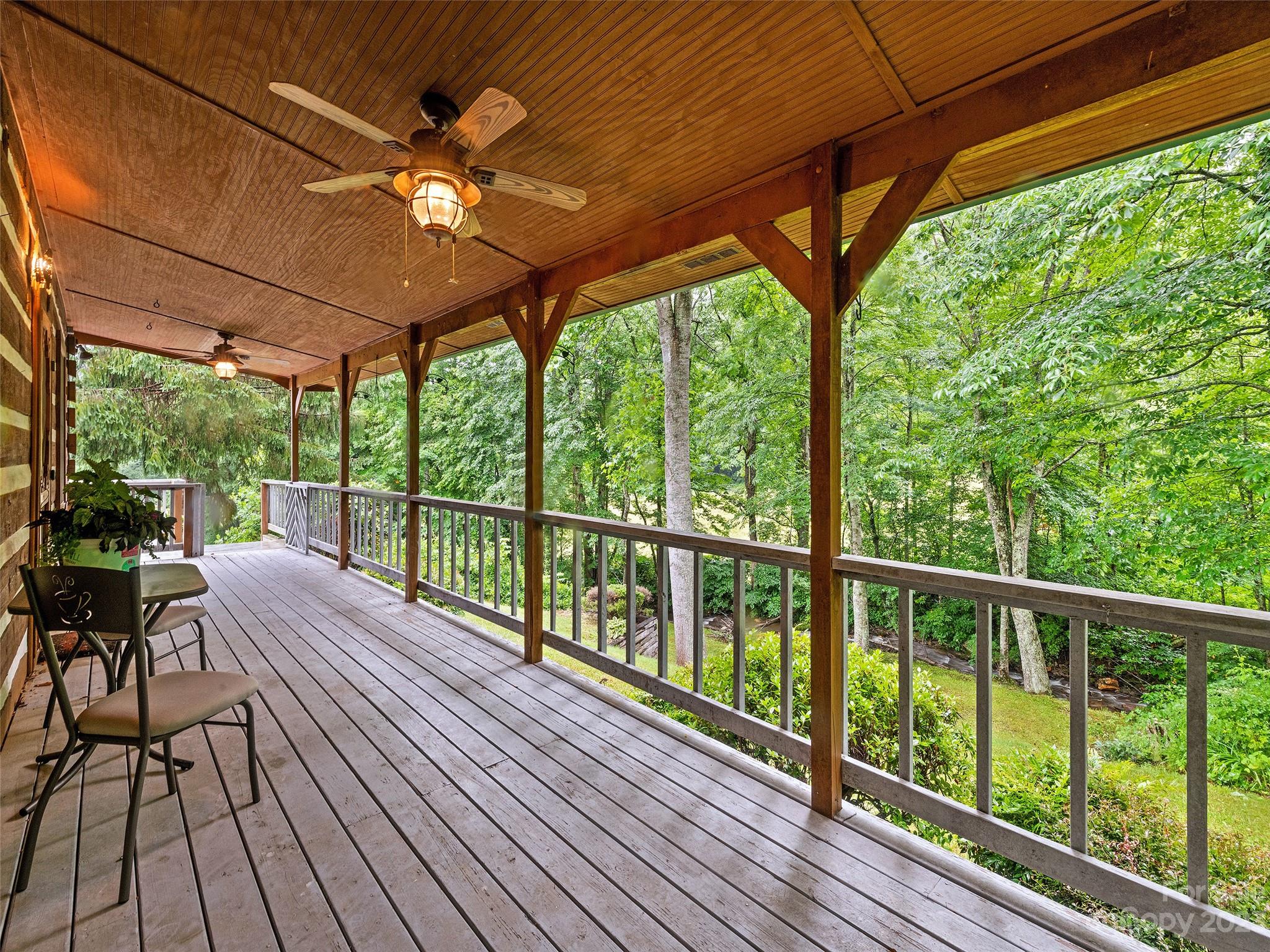 205 Columbus Cove Road Waynesville, NC 28785 - Photo 10 of 33 a view of a balcony with furniture and wooden floor