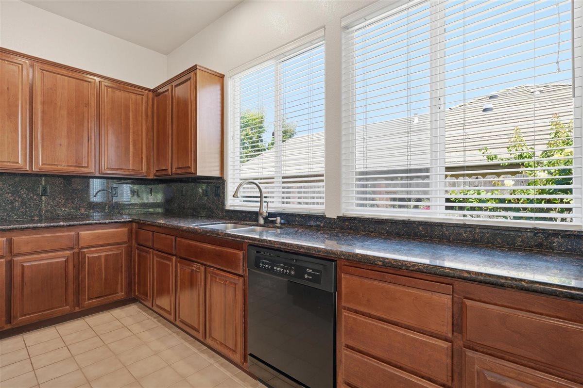 4129 Poppleton Way Carmichael, CA 95608 - Photo 16 of 48 a kitchen with stainless steel appliances granite countertop a sink and a large window