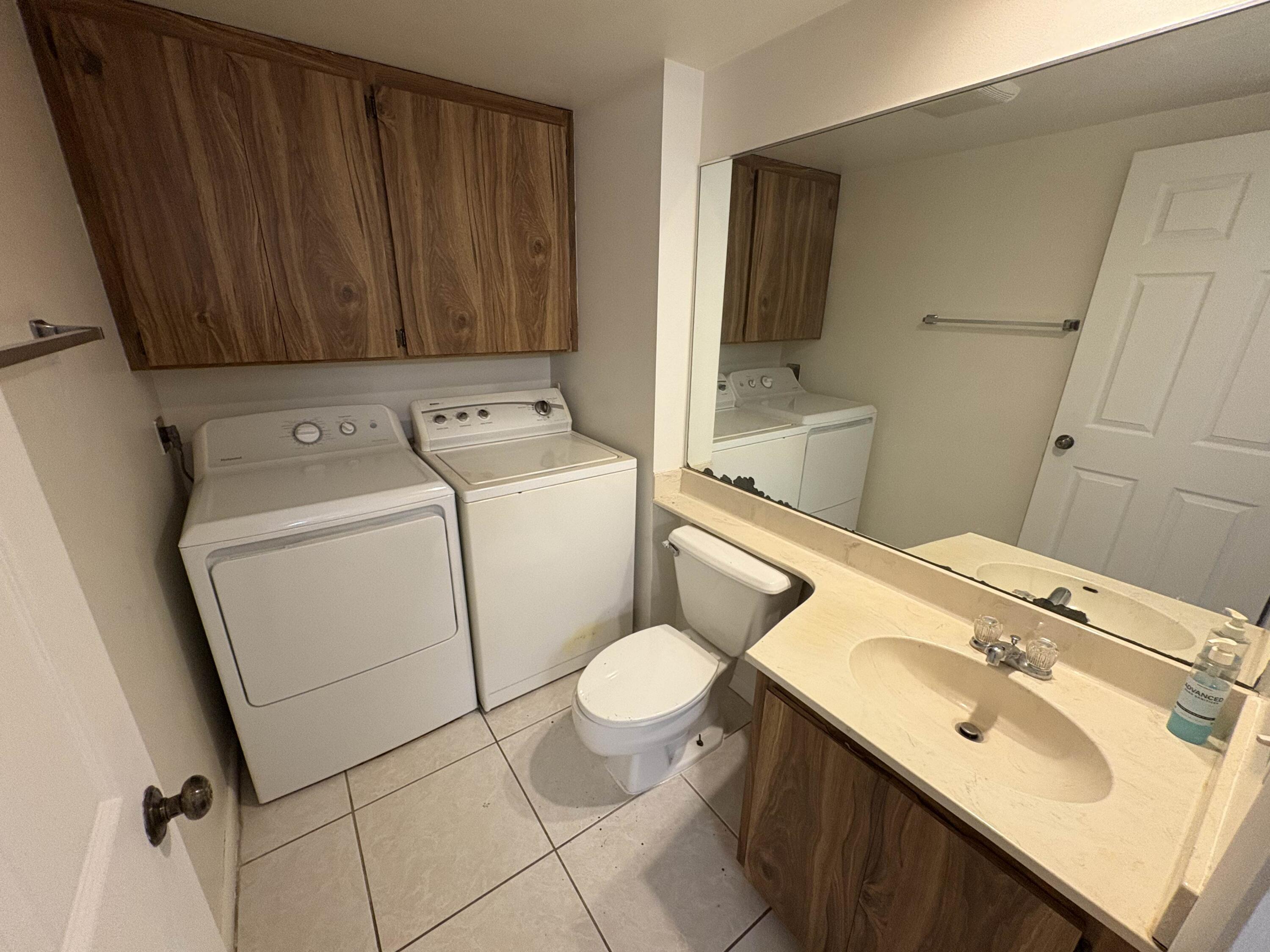 2950 Southwest 22nd Circle, Unit 4A Delray Beach, FL 33445 - Photo 11 of 42 a bathroom with a sink toilet and shower