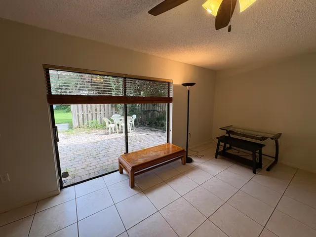 a bedroom with a bed couch and a chandelier