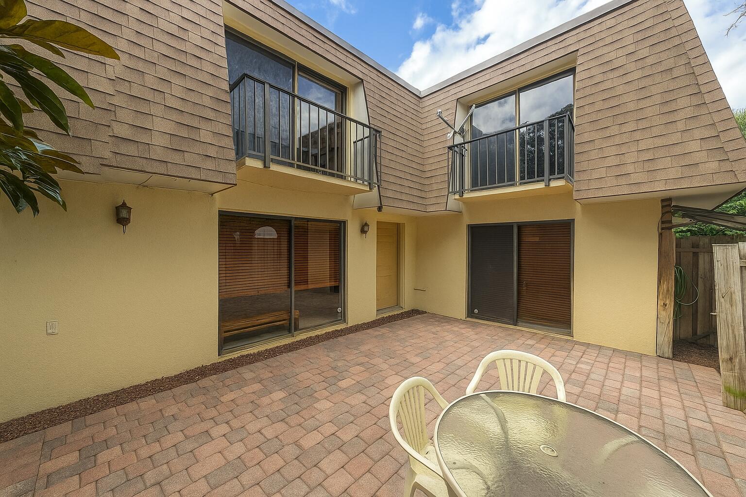 2950 Southwest 22nd Circle, Unit 4A Delray Beach, FL 33445 - Photo 2 of 42 a view of a house with windows