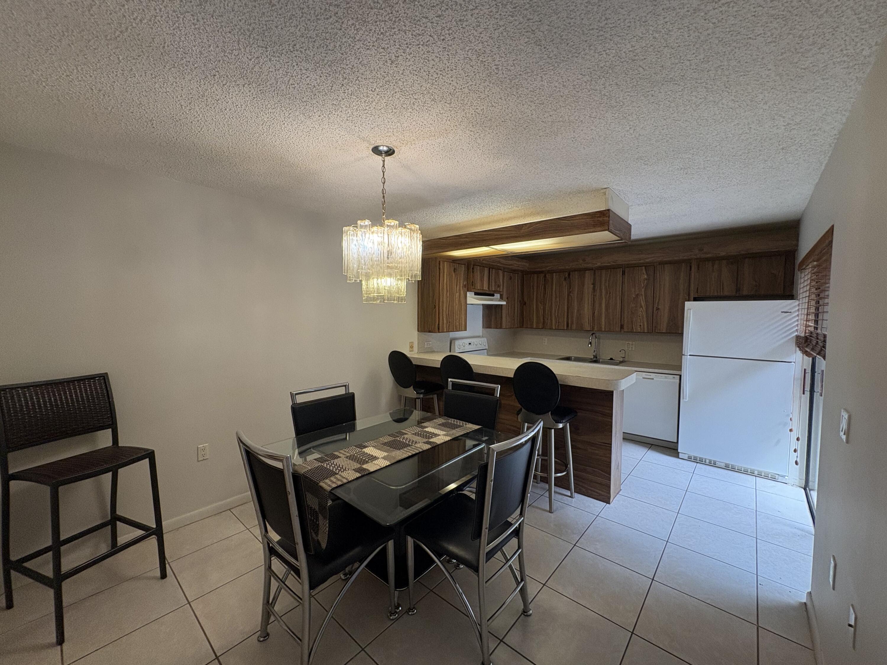2950 Southwest 22nd Circle, Unit 4A Delray Beach, FL 33445 - Photo 9 of 42 a view of a dining room with furniture
