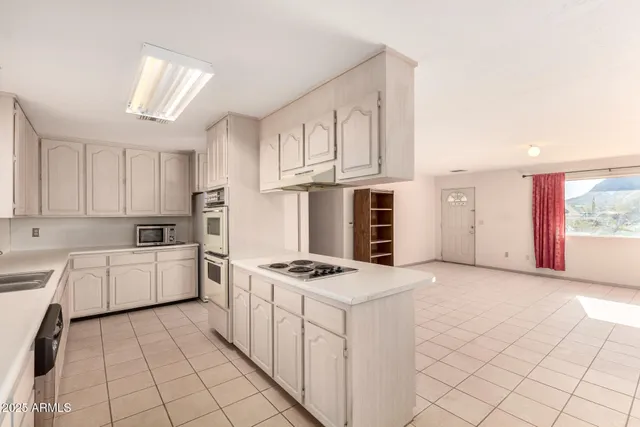 a kitchen with cabinets and window