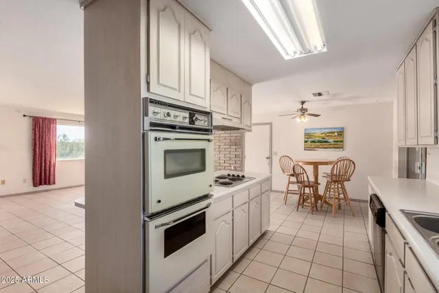 a kitchen with granite countertop cabinets and steel appliances
