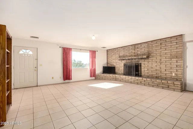 a view of a livingroom with furniture and a fireplace