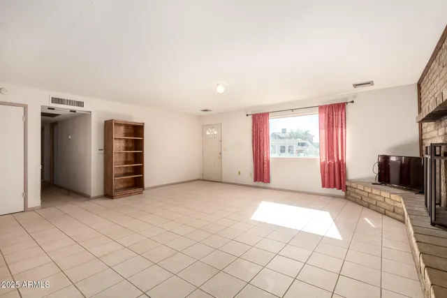 a view of an empty room with a fireplace