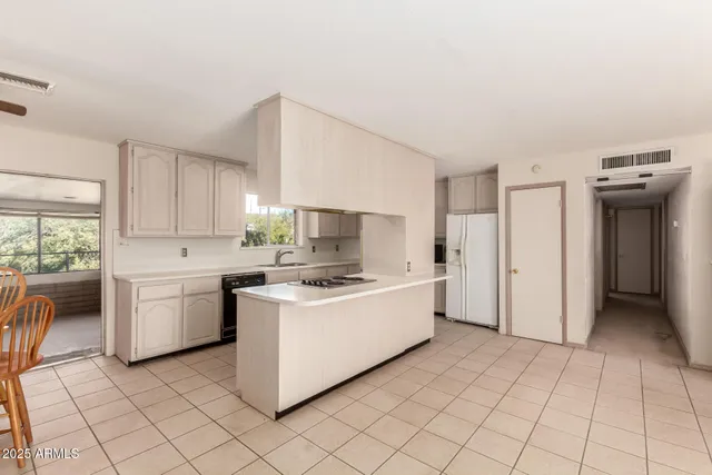 a kitchen with a stove a sink and a refrigerator
