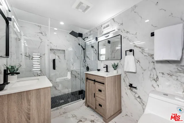 a spacious bedroom with a bed and a potted plant