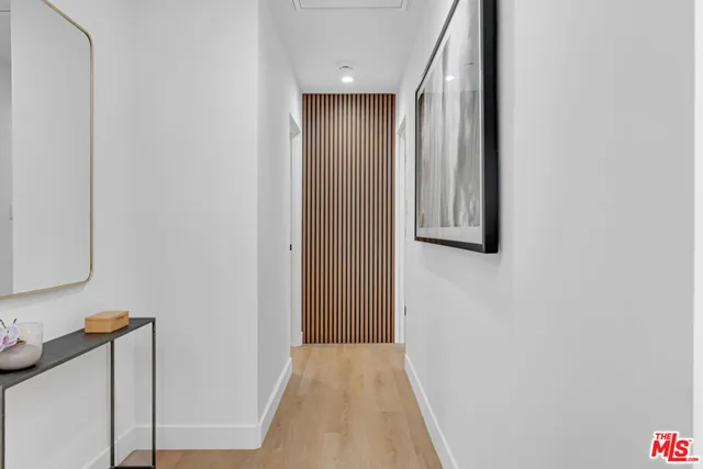 a kitchen with a sink a potted plant and cabinets