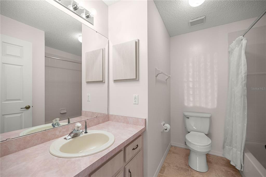 8485 Southwest 60th Circle Ocala, FL 34476 - Photo 13 of 22 a bathroom with a granite countertop sink toilet and shower