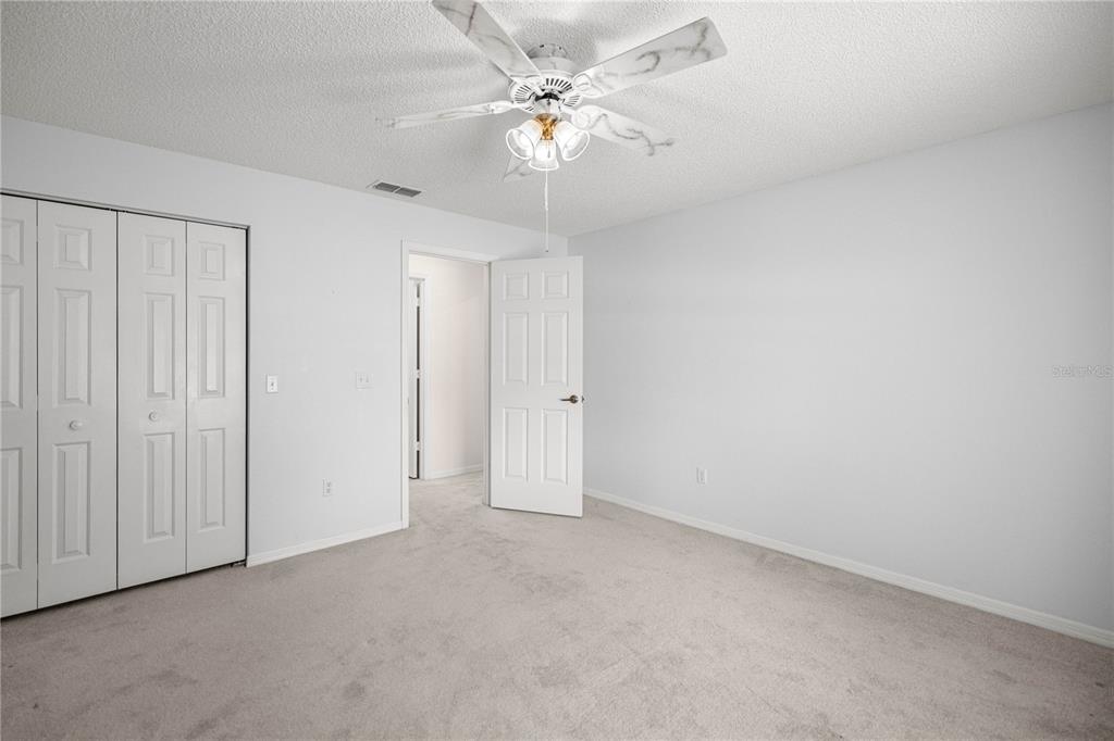 8485 Southwest 60th Circle Ocala, FL 34476 - Photo 14 of 22 a view of an empty room with a ceiling fan