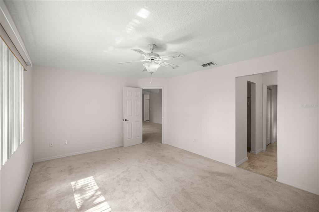 8485 Southwest 60th Circle Ocala, FL 34476 - Photo 16 of 22 an empty room with windows and ceiling fan