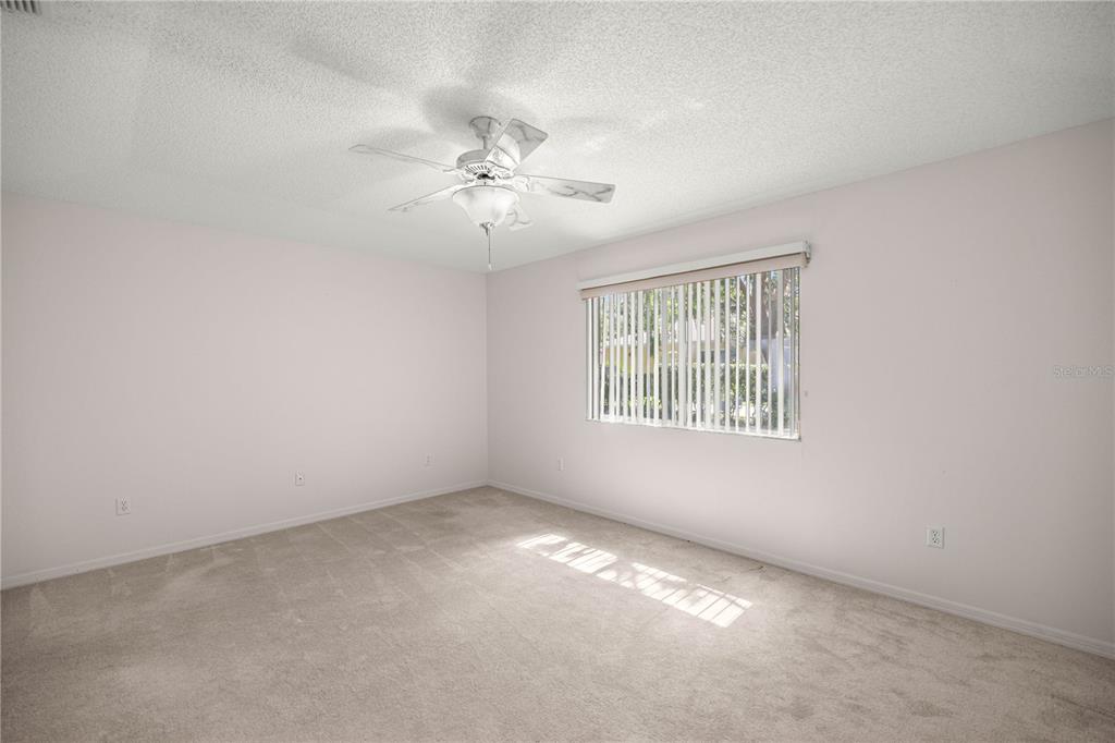 8485 Southwest 60th Circle Ocala, FL 34476 - Photo 17 of 22 an empty room with a window and a fan