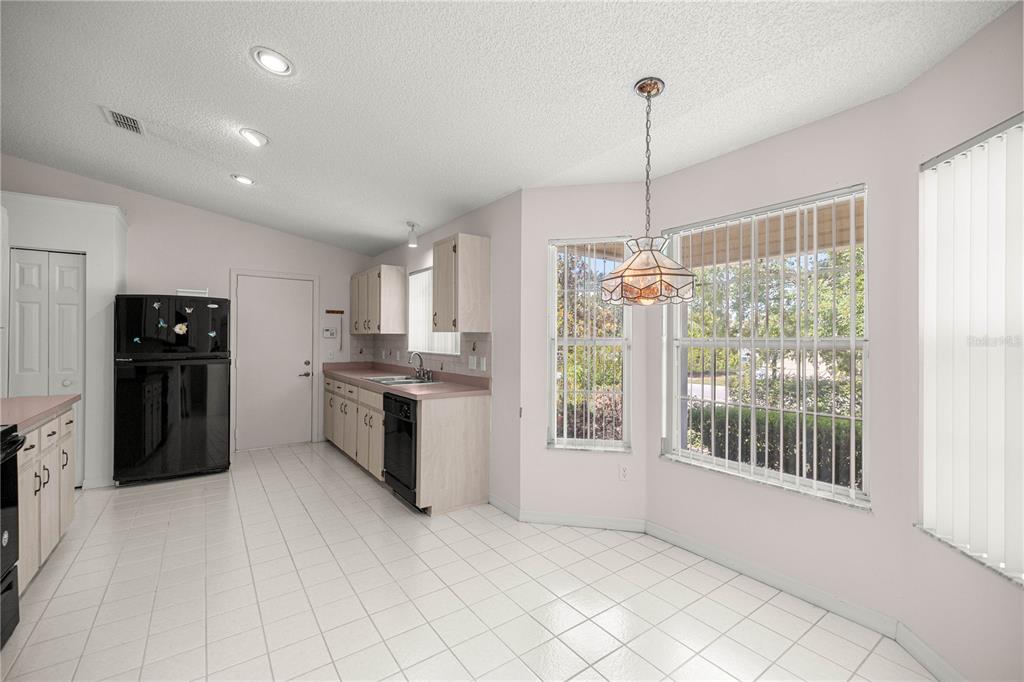 8485 Southwest 60th Circle Ocala, FL 34476 - Photo 8 of 22 a kitchen with kitchen island a counter top space appliances and a counter top space