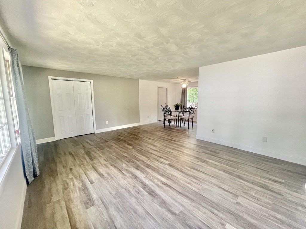 529 Howard Street Brockton, MA 02302 - Photo 11 of 34 a view of empty room with wooden floor and fan