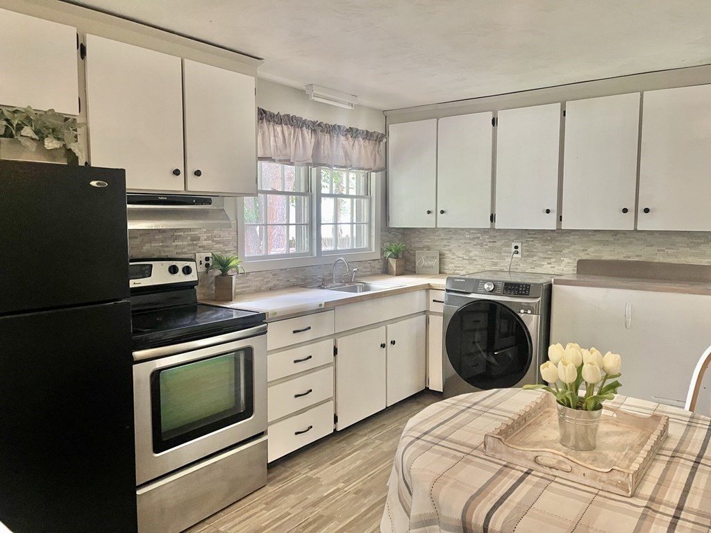 529 Howard Street Brockton, MA 02302 - Photo 17 of 34 a kitchen with granite countertop white cabinets and white appliances