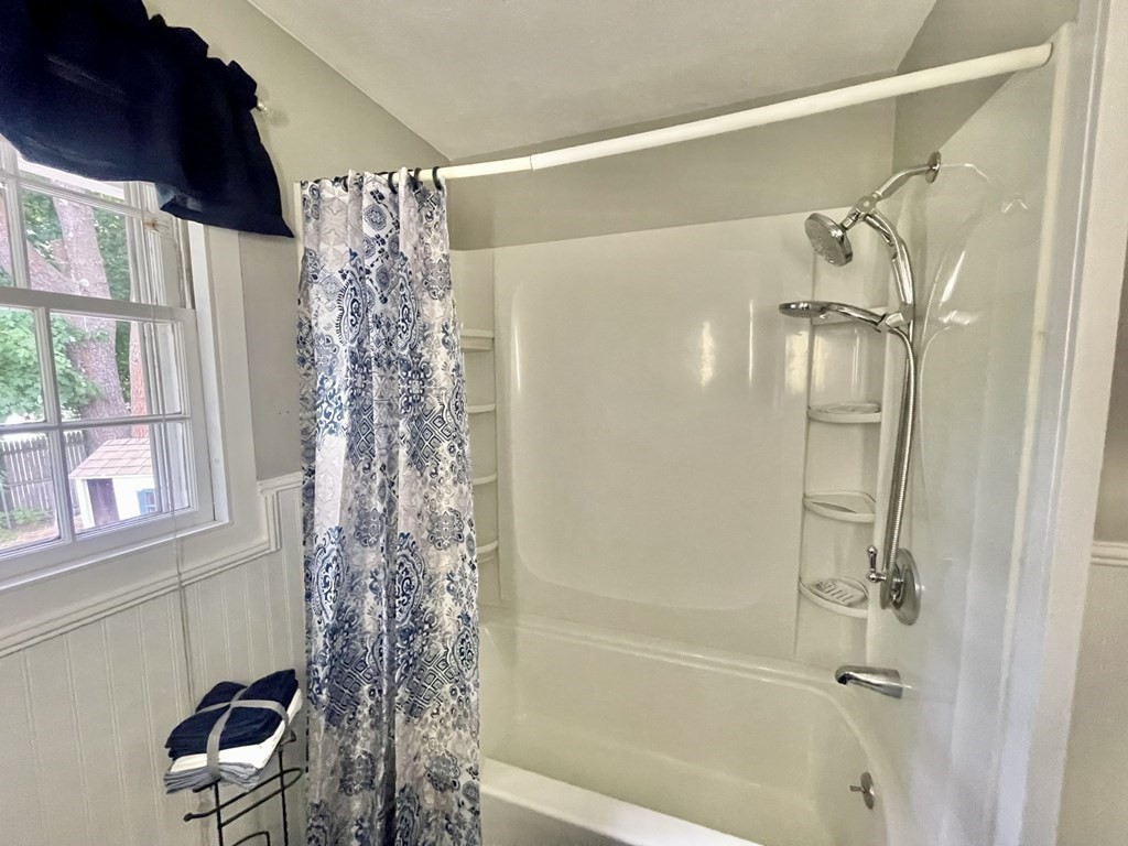 529 Howard Street Brockton, MA 02302 - Photo 24 of 34 a bathroom with a shower curtain and a window
