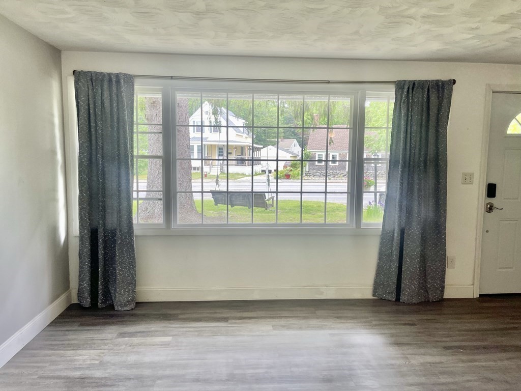 529 Howard Street Brockton, MA 02302 - Photo 9 of 34 an empty room with wooden floor and windows