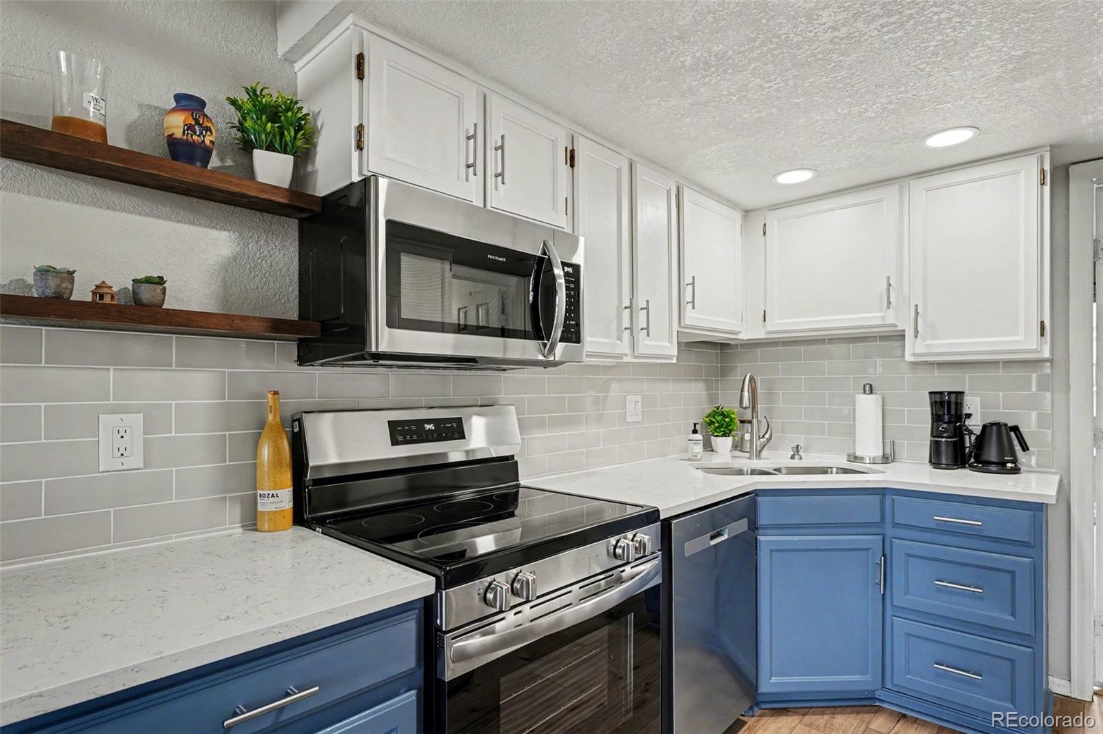 1885 South Quebec Way, Unit B24 Denver, CO 80231 - Photo 3 of 22 a kitchen with cabinets and appliances