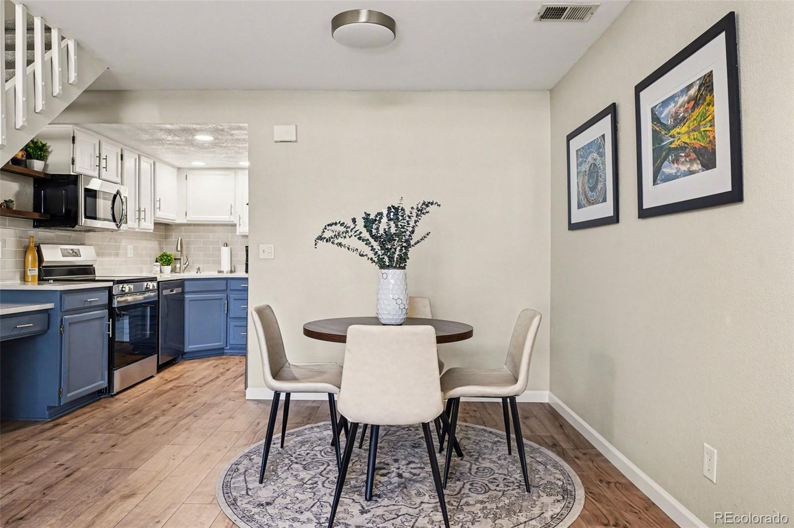 1885 South Quebec Way, Unit B24 Denver, CO 80231 - Photo 6 of 22 a view of a dining room with furniture and wooden floor