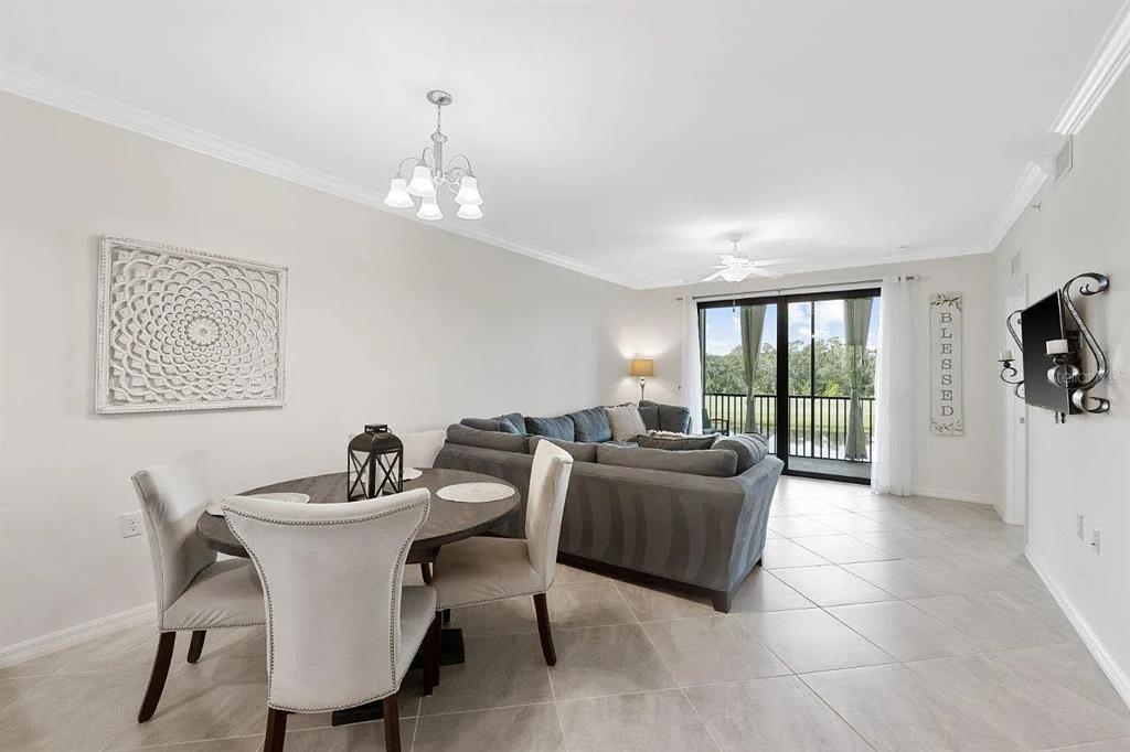 17724 Gawthrop Drive, Unit 204 Bradenton, FL 34211 - Photo 11 of 55 a living room with furniture a flat screen tv and a window