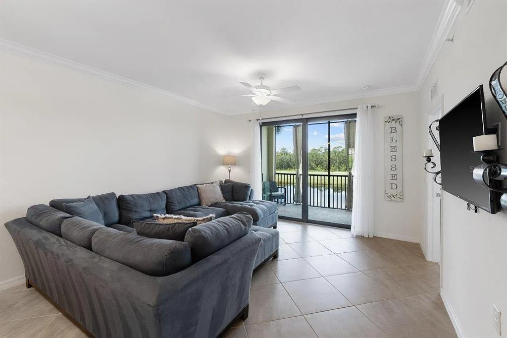 17724 Gawthrop Drive, Unit 204 Bradenton, FL 34211 - Photo 12 of 55 a living room with furniture and a flat screen tv