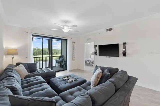 a living room with furniture and a chandelier
