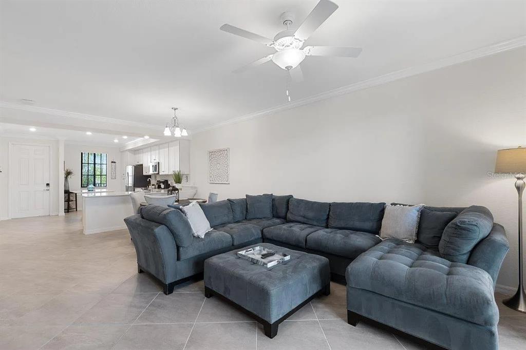 17724 Gawthrop Drive, Unit 204 Bradenton, FL 34211 - Photo 14 of 55 a living room with furniture and a chandelier