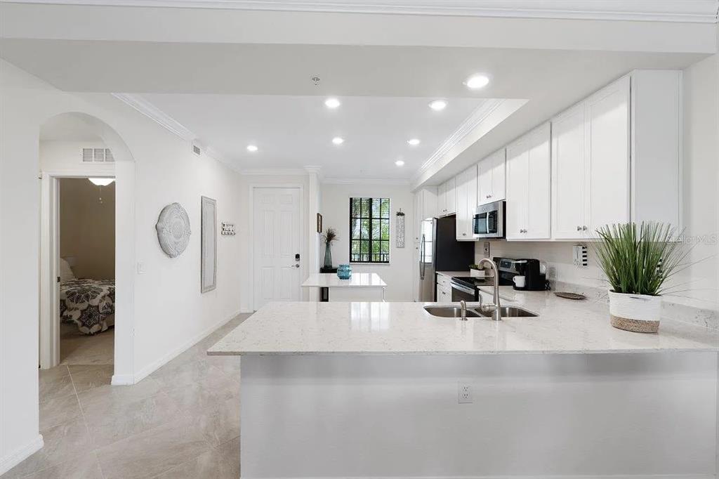 17724 Gawthrop Drive, Unit 204 Bradenton, FL 34211 - Photo 18 of 55 a room with stainless steel appliances a sink a counter top space cabinets and a potted plant