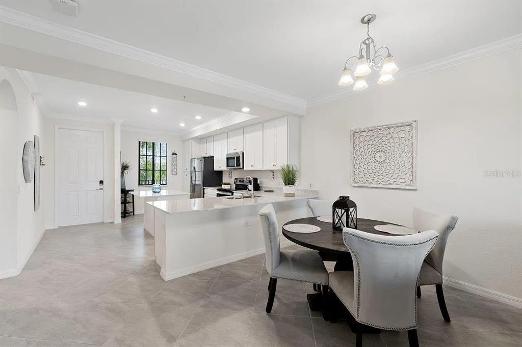 17724 Gawthrop Drive, Unit 204 Bradenton, FL 34211 - Photo 19 of 55 a view of a dining room with furniture and chandelier