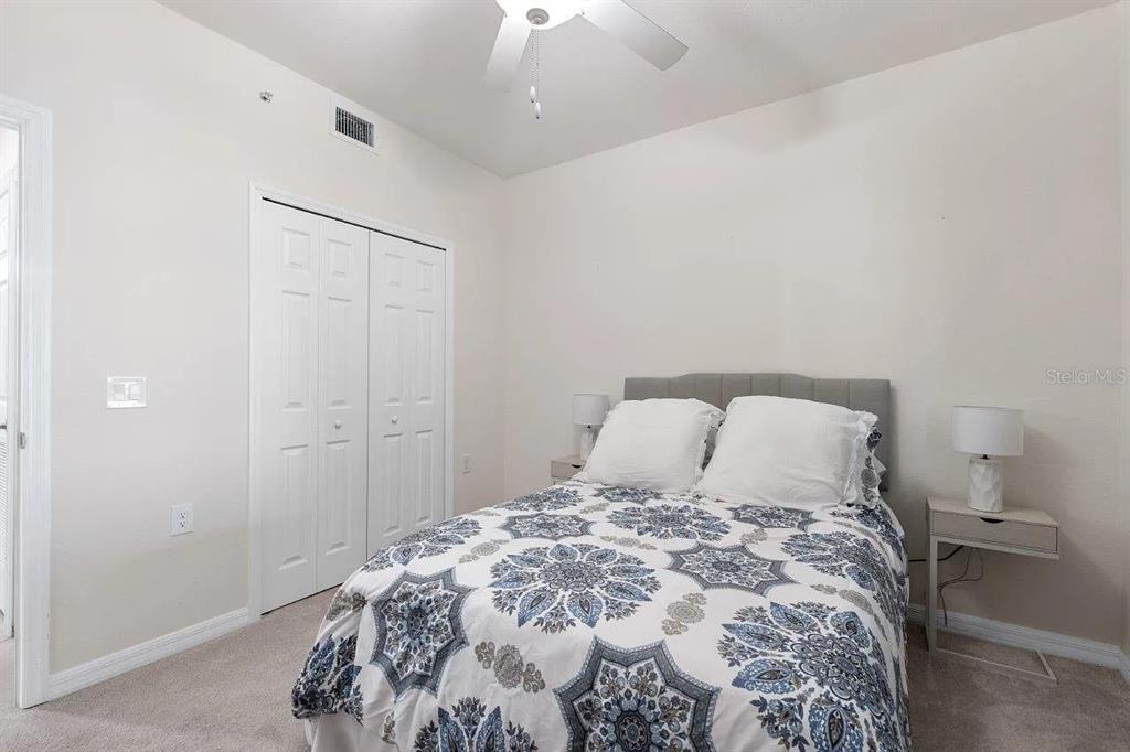 17724 Gawthrop Drive, Unit 204 Bradenton, FL 34211 - Photo 21 of 55 a bedroom with a bed and a chandelier