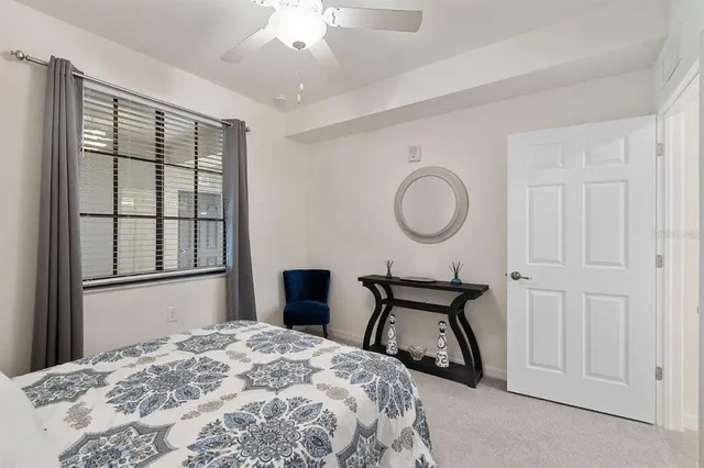 a bedroom with a bed and a mirror