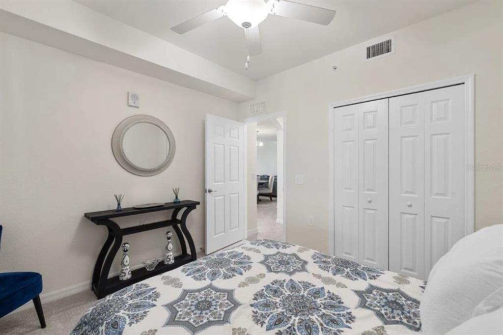 17724 Gawthrop Drive, Unit 204 Bradenton, FL 34211 - Photo 23 of 55 a bedroom with a bed and a mirror
