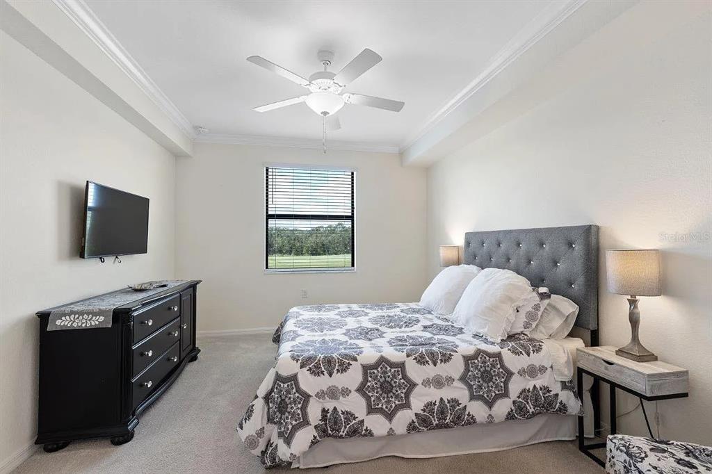17724 Gawthrop Drive, Unit 204 Bradenton, FL 34211 - Photo 24 of 55 a bedroom with a bed and flat screen tv